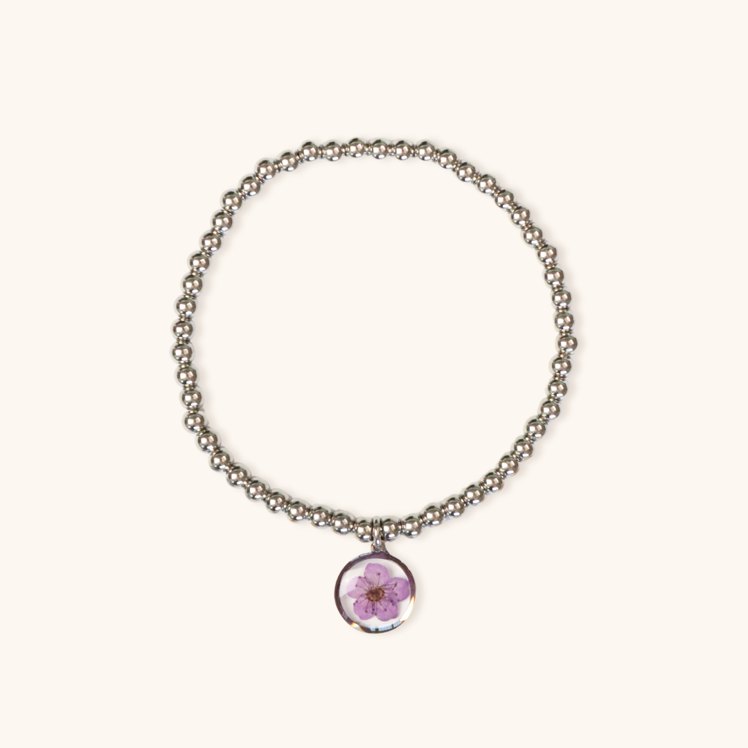 Bracciale elastico in acciaio inossidabile e ciondolo in resina con fiore viola