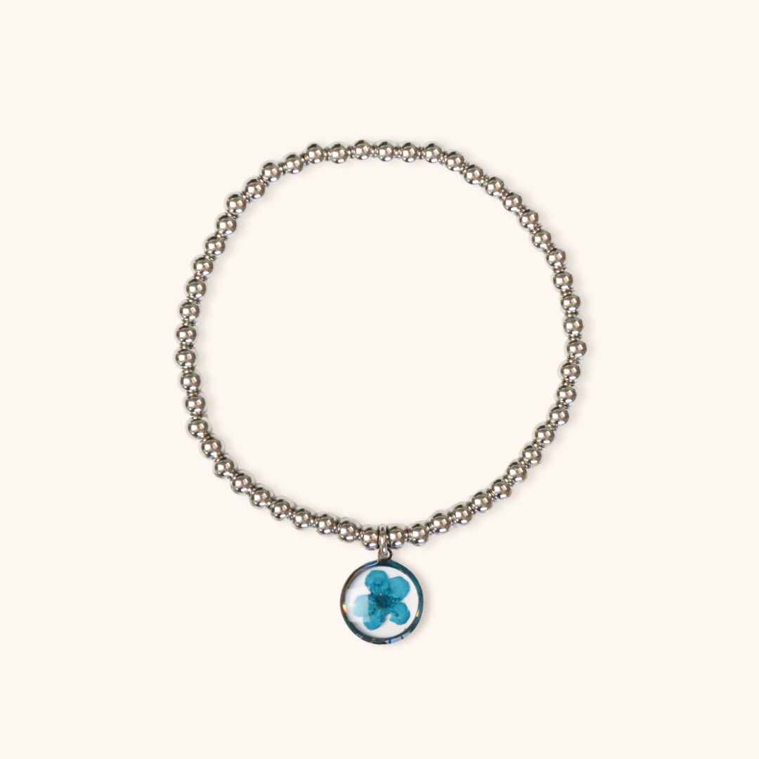 Bracciale elastico in acciaio inossidabile e ciondolo in resina con fiore blu