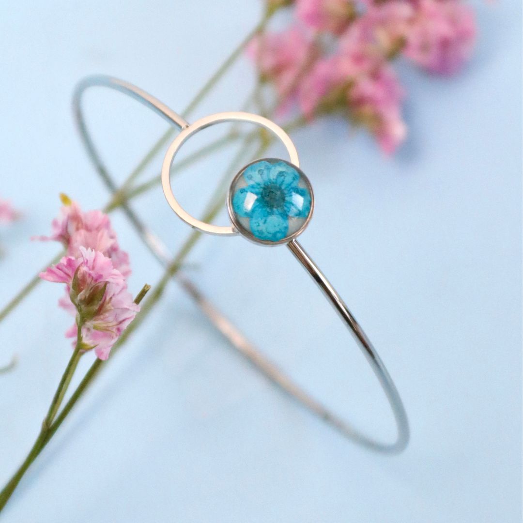 Bracciale ABBRACCIAMI in acciaio inox con resina e fiore selvatico blu