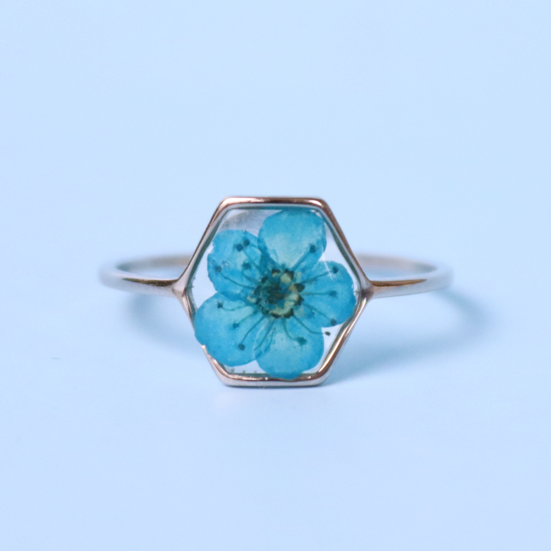 Anello in acciaio inox e fiore selvatico blu intersecato nella resina