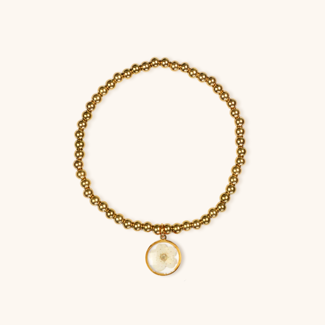 Bracciale elastico in acciaio inossidabile e ciondolo in resina con fiore selvatico bianco
