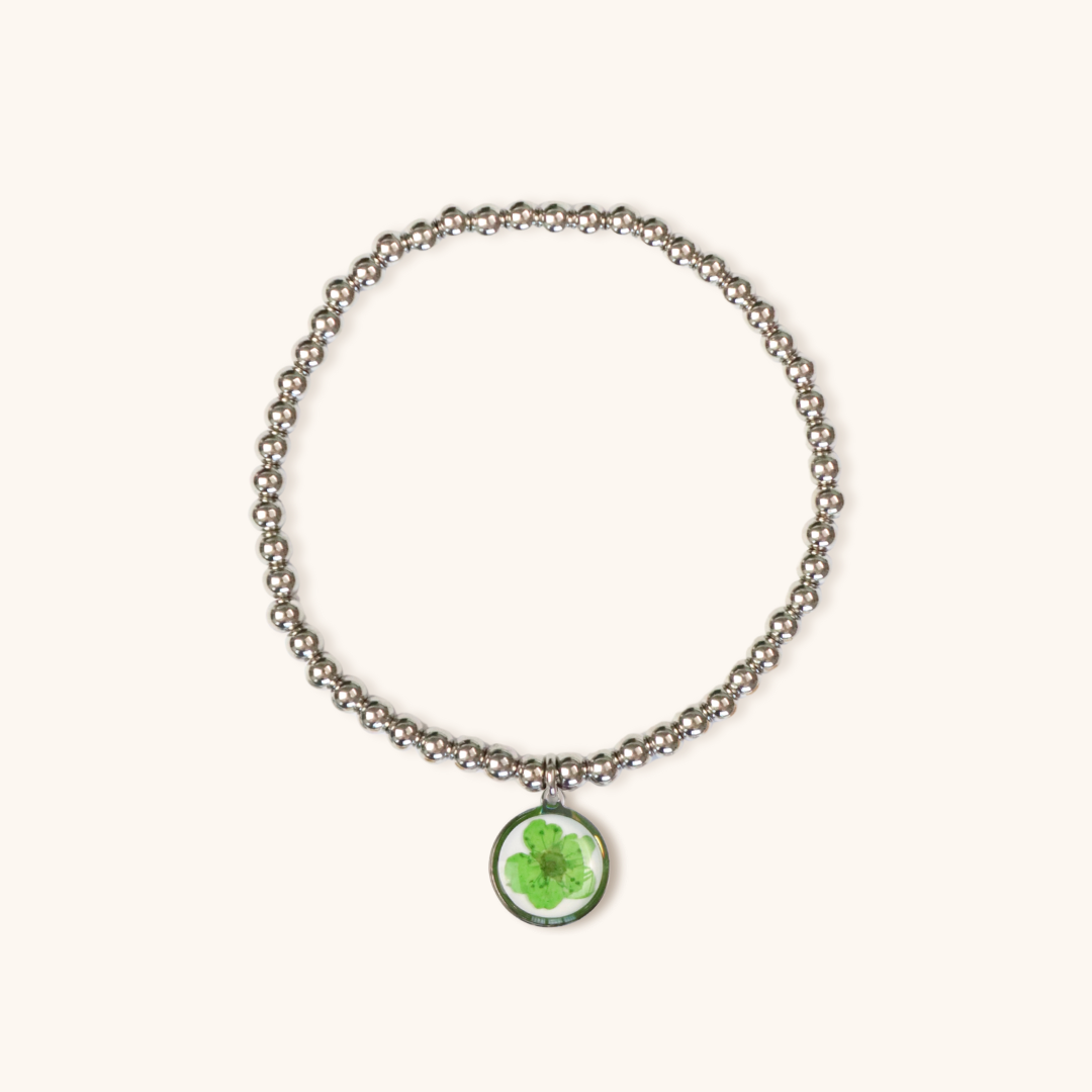Bracciale elastico in acciaio inossidabile e ciondolo in resina con fiore verde