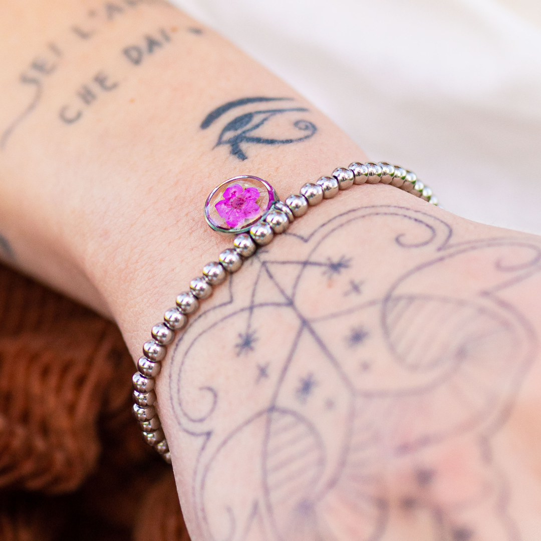 Bracciale elastico in acciaio inossidabile e ciondolo in resina con fiore fucsia
