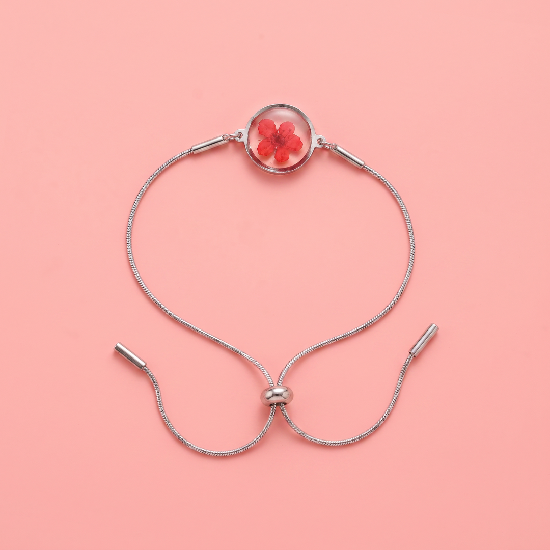 Bracciale scorrevole in acciaio inox e fiore rosso preservato nel ciondolo