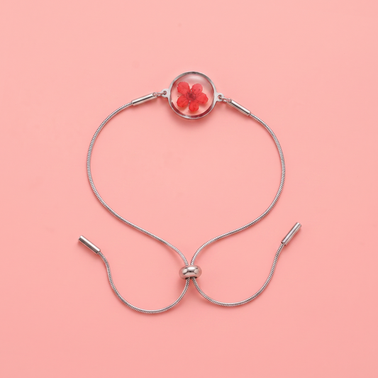 Bracciale scorrevole in acciaio inox e fiore rosso preservato nel ciondolo