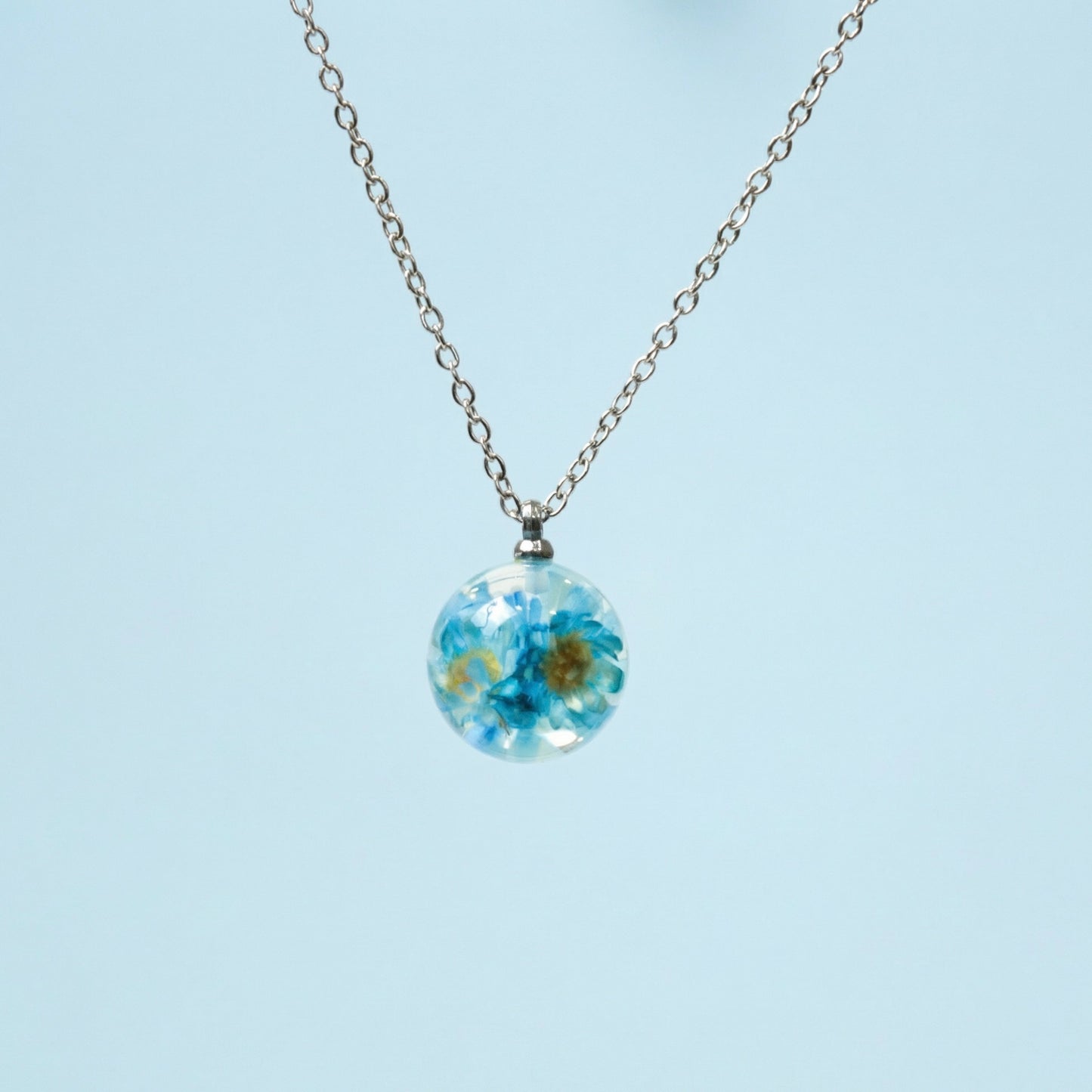 Collana BOLLA in acciaio inox con sfera in resina e fiori di Glixia blu