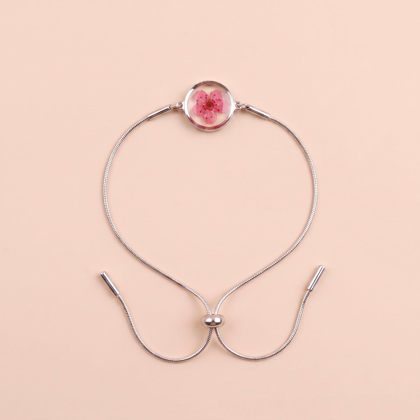 Bracciale scorrevole in acciaio inox e fiore magenta preservato nel ciondolo