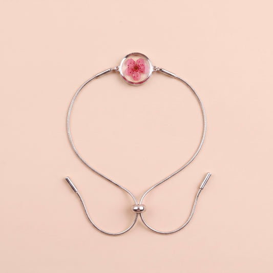 Bracciale scorrevole in acciaio inox e fiore magenta preservato nel ciondolo