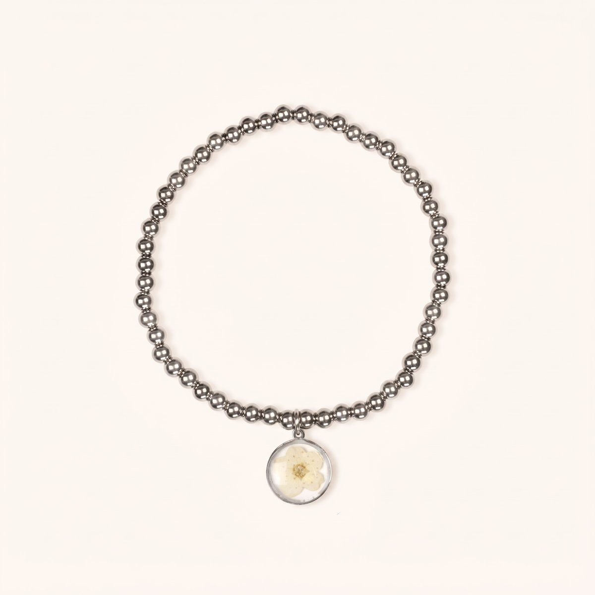 Bracciale elastico in acciaio inossidabile e ciondolo in resina con fiore selvatico bianco